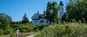 Girl walking by Point Iroquois Lighthouse